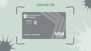 Image of the PenFed Pathfinder® Rewards Visa Signature® Card, which has a sleek gray design with geometric patterns. The card features the "Pathfinder Rewards" logo in white, the PenFed branding, a contactless payment symbol, and the Visa Signature logo in the bottom right corner. Above the card, the text "CAXIAS ON" appears in bold green letters. The background is light green with abstract shapes and black corner accents, giving a modern and dynamic look.