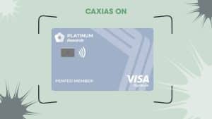 Image of the PenFed Platinum Rewards Visa Signature® Card, featuring a sleek light blue design with angular patterns. The card displays the "Platinum Rewards" logo in white, the PenFed branding, a contactless payment symbol, and the Visa Signature logo in the bottom right corner. Above the card, the text "CAXIAS ON" appears in bold green letters. The background is light green with abstract black and white shapes, giving it a modern and dynamic look.