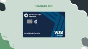Image of the PenFed Power Cash Rewards Visa Signature® Card, featuring a sleek navy blue design with angular patterns. The card displays the "Power Cash Rewards" logo in white, the PenFed branding, a contactless payment symbol, and the Visa Signature logo in the bottom right corner. Above the card, the text "CAXIAS ON" appears in bold green letters. The background is light green with abstract black and white shapes, giving it a modern and dynamic look.