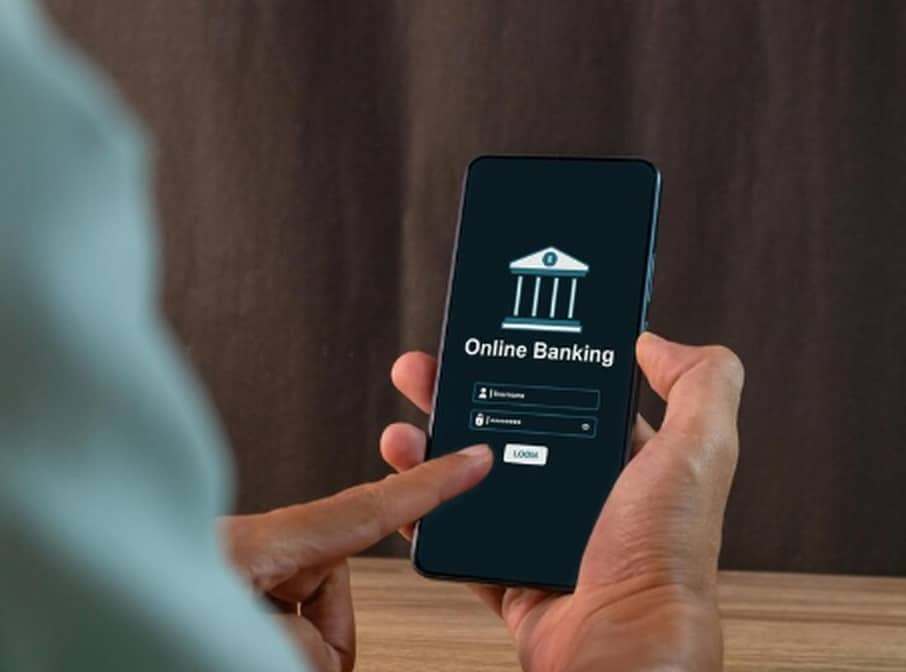 Person using a smartphone to log in to an online banking app, illustrating the convenience and accessibility offered by digital banks.