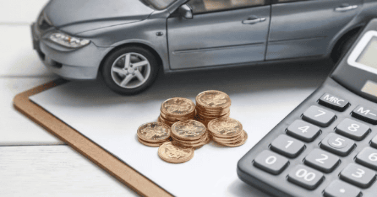 Car model with stacked coins and a calculator on a desk, representing financial information about car loans or vehicle costs.